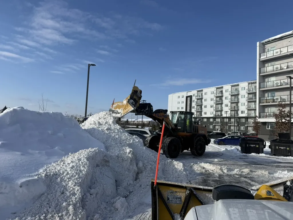Case 621 loader stacking snow at a multi-residential property