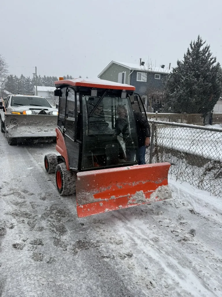 OneBluePlanet sidewalk snow machine servicing a pedestrian route