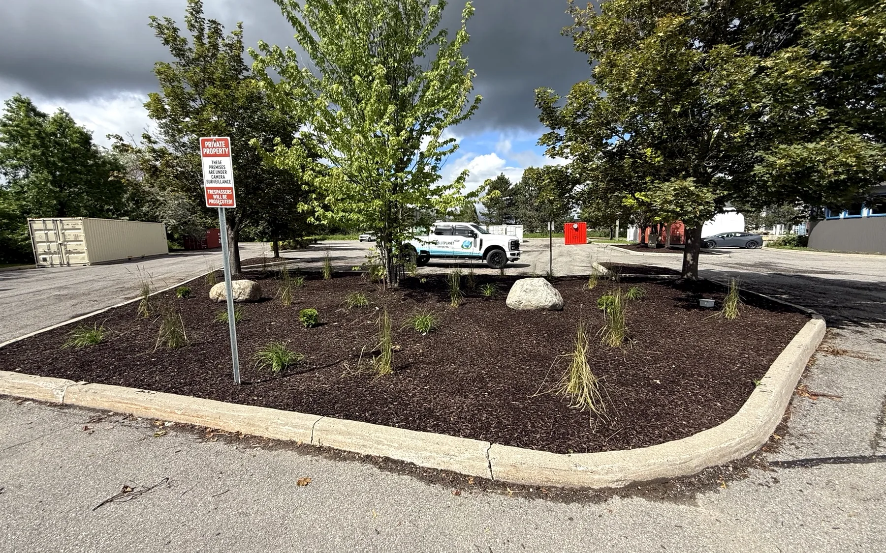 Maintained commercial landscape bed and OneBluePlanet truck